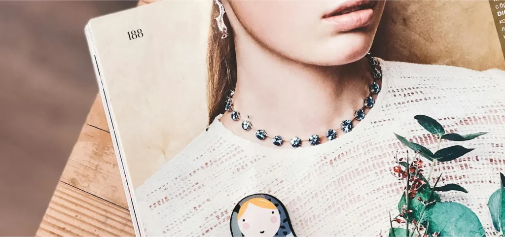 Beyond gender, beyond gloss—this is the curated self we all perform. Flatlay of a fashion magazine showing a woman’s portrait, symbolizing identity, femininity, and the performance of self—central to Vagina Sauna’s raw, unfiltered storytelling.