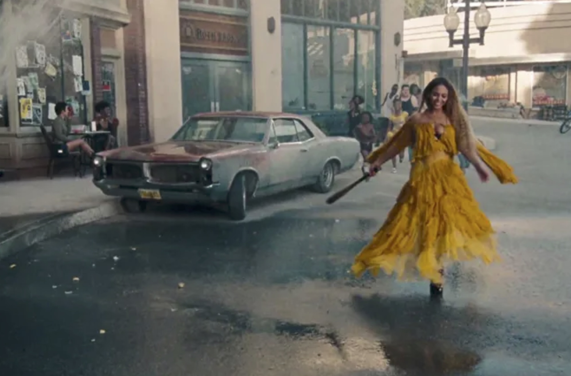 Beyoncé embodying her villain era in Lemonade, wearing a yellow dress and holding a bat mid-stride