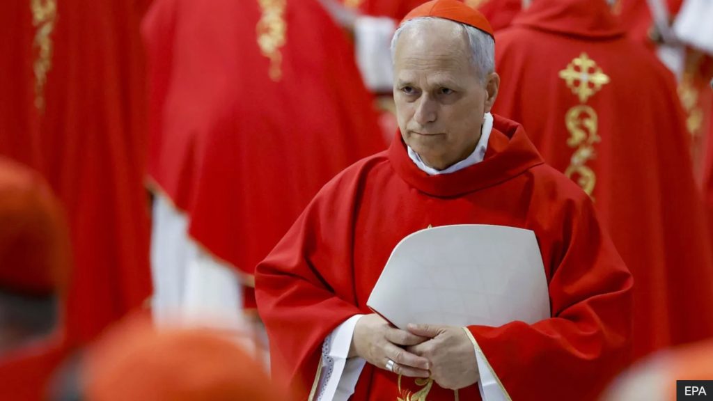 Pope Leo Gaza Silence - Cardinal Robert Prevost in red liturgical vestments during a Vatican ceremony, before being elected Pope Leo XIV.