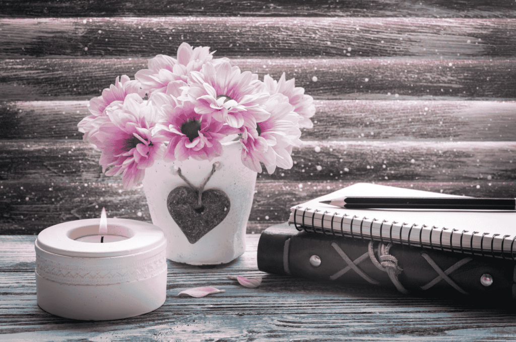 Writing instead of Therapy - Notebook and pen beside a candle and flowers—symbolizing emotional writing and quiet reflection”