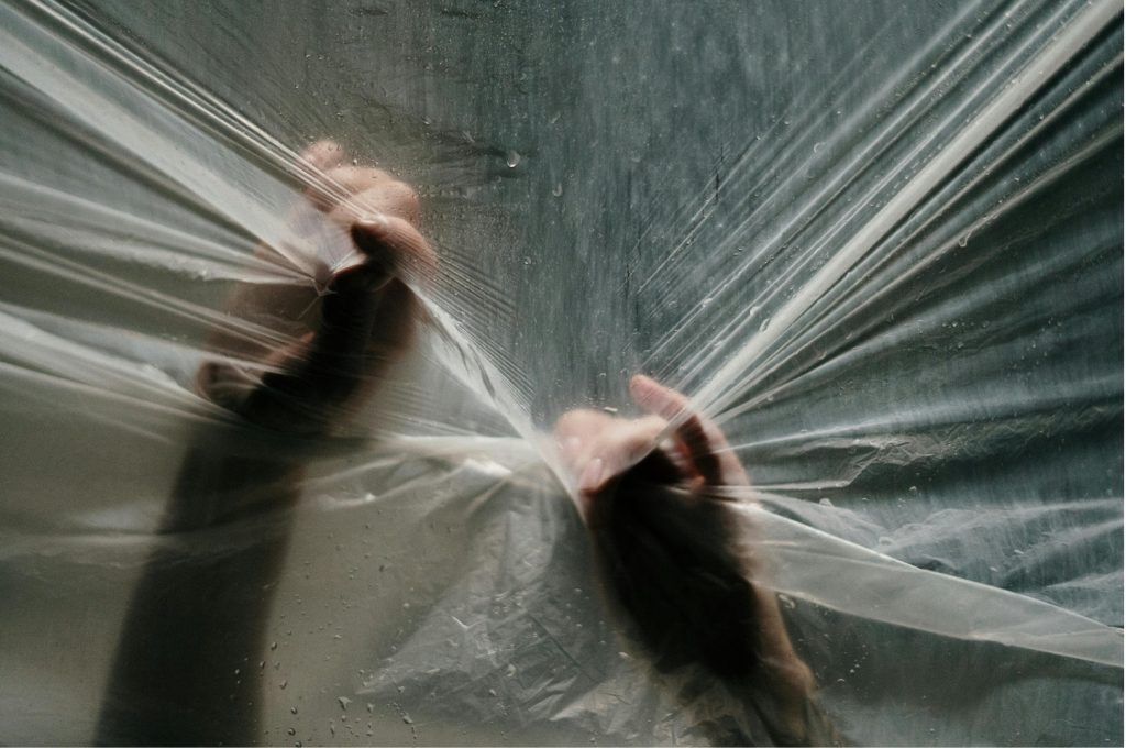 Why Nightmares Happen - Hands pressing against a plastic sheet from underneath, symbolizing emotional pressure and suppressed fear