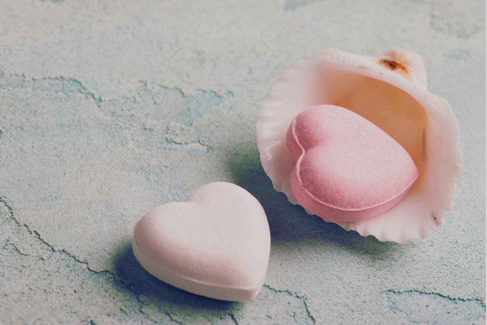 Narcissist Relationship Playbook - Two pastel heart-shaped objects, one inside a shell—symbolizing charm and emotional bait.