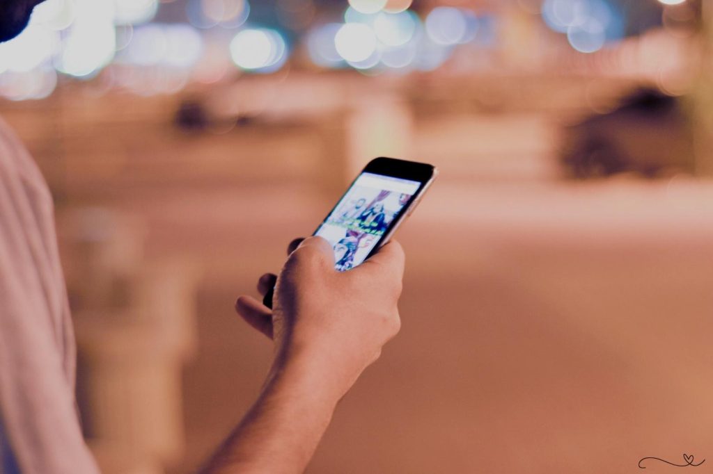 Israel social media propaganda - Person scrolling through social media on a smartphone