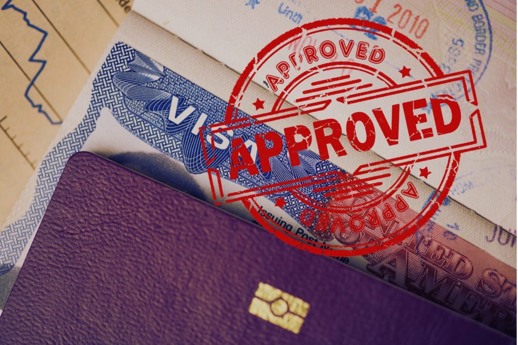 Permission economy - A close-up of a passport and visa page with a bold red “APPROVED” stamp, symbolizing border control and permission.